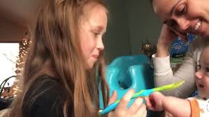 big sister feeding little brother