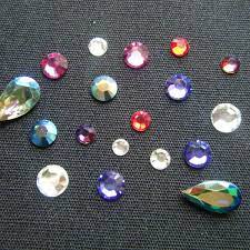 Once all the rhinestones are in place, remove the design sheet very carefully place the transfer sheet (with the rhinestones arranged) onto the surface of the fabric. How To Iron And Glue Rhinestones To Your T Shirts And More Feltmagnet