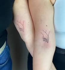 Praying hands tattoo design to fill your soul. Fine Line Matching Holding Hands Tattoo For Mother And