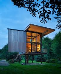 This is a classic beach house built on pilings and designed for a narrow lot. Steel Clad 350 Sq Ft Modern Cabin On Stilts With Shutters