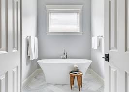 The herringbone tile pattern is framed with 6x12 manganese spanish tile. Gray Master Bath With Large Marble Herringbone Floor Tiles Transitional Bathroom