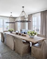 Consider a barn wood bench instead of chairs or a combination of the two. Light Salvaged Wood Trestle Dining Table With Rope And Iron Ring Chandeliers Cottage Dining Room