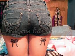 A bow ribbon is delicate and pretty in appearance. Red Bow Tattoos On Back Thighs