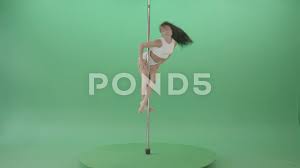 Young woman spinning in pole dance on gr... | Stock Video | Pond5
