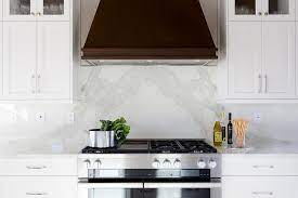 White kitchen cabinets are classic and usually a safe design decision. Dark Brown Vent Hood With White Kitchen Cabinets Transitional Kitchen