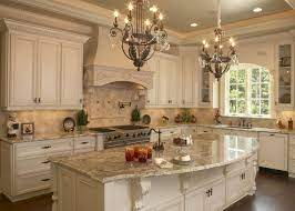 All white kitchen with white moldings and cabinetry, wood top island, wide plank wood flooring, brass hardware. French Country Kitchen Cabinets You Ll Love In 2021 Visualhunt