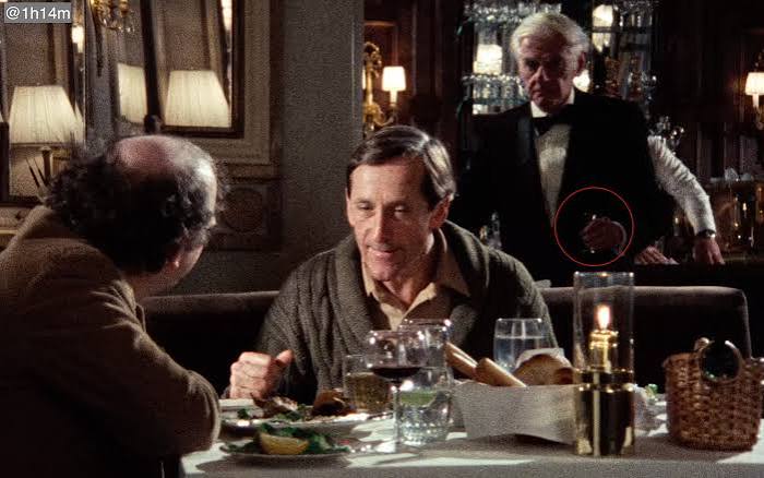 In "My Dinner with Andre" (1981) the waiter wanted to serve the amaretto  before it was ordered. Then he finally serves it after Wally gives his  speech about the future/science/omens etc. :