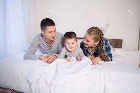 Maybe you would like to learn more about one of these? Mom Dad And Young Son Sleep On The Bed In The Bedroom Stock Photo Picture And Royalty Free Image Image 114119167