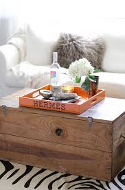 Sun pattern on the top surface, underside in lacquered sycamore wood. Trunk Coffee Table With Orange Hermes Tray Transitional Living Room