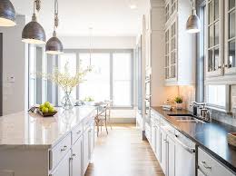 The stainless steel double oven and range hood compliment the white cabinetry and metal hardware. Mixed Kitchen Countertop Ideas Transitional Kitchen