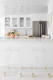 white marble kitchen with lucite bar stools via sydne summer kitchen remodel design white marble kitchen kitchen marble