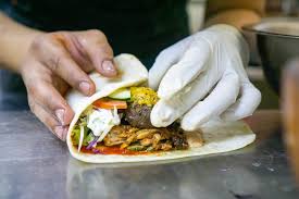 Check spelling or type a new query. Close Up Food Photo Of Kitchen Chef Rolling A Doner Durum Kebab Roll With Grilled Lamb Cheese Zucchini Tomatoes Cucumber Cabbage Tzatziki And Cocktail Sauce On A Kitchen Countertop Creative Commons