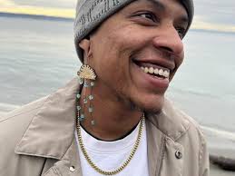 Amari Davis (they/them) HELD by Amari