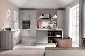 For subtle contrast, two different shades of the same calm colour tend to work better on cabinetry than three or four, which can look like a design mistake. Create A Soothing Look By Pairing Light Dove Grey Cabinets With Pastel Pink Wallpaper And Understa Pink And Grey Kitchen Grey Shaker Kitchen Grey Kitchen Walls