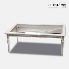 Crafted from solid wood and metal, it features a comfortable combo of white and natural wood color tone and creates a warm, inviting ambiance for your living room or home office. Louis Xvi Coffee Table Glass Top Antique White Christophe Living