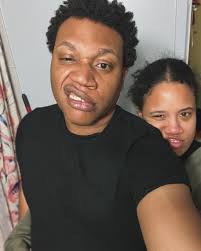 Behind every great man is a great woman making funny faces with him.