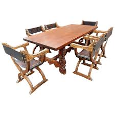 Spanish Colonial Dining Table With Six Elaborate Carved Wood And Leather Chairs Leather Chair Dining Table Hanging Furniture