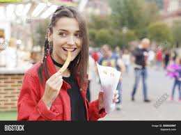 A hungry wolf was out searching for a meal. Girl In The Fair Eating Spanish Snack Named Churros Image Stock Photo 202632967