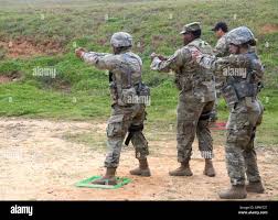 Three members of the 2nd Battalion, 60th Infantry Regiment team of active  duty drill sergeants from Fort Jackson, S.C. simulate their actions before  they compete in the combined arms multi-gun (rifle and