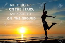 Keep Your Eyes On The Stars And Your Feet On The Ground Inspirational Motivational Quote With Happy Young Woman Silhouette Dancing On The Sea Coast Horizontal Colored Image With Sunset Background Stock