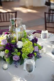 Purple Green And White Flower Centerpieces With The Oscar In The C Green Wedding Centerpieces White Flower Centerpieces Purple Wedding Centerpieces
