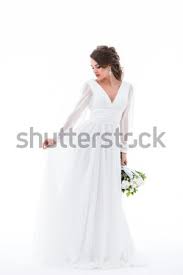From colourful to cascading, monochromatic and textured, each take your pick from these stunning bouquets featured in real weddings and style shoots across the elegant wedding blog for your spring. Brunette Bride Posing In Elegant White Dress With Wedding Bouquet Isolated On White Stock Photo C Lightfieldstudios 9098525 Stockfresh
