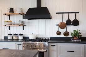 Transitional kitchen with black shaker cabinets, accented with brass pulls. Contemporary Black And White Kitchen With White Shiplap Walls Hgtv