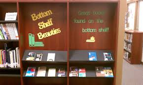 Library Display Sometimes The Books On The Bottom Shelf Are Hidden From Looking Eyes This Pulls Them I Library Displays Library Book Displays Library Decor