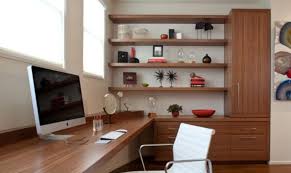 Library in corner of living room with small bench under window and recessed lighting source: 15 Corner Wall Shelf Ideas To Maximize Your Interiors