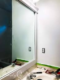 If you don't like how far it sticks out with the clips you could notch out the back of the *since this is a bathroom mirror and near water and moisture, i am using spar varnish as a top coat. Bathroom Makeover On A Budget How To Frame A Mirror Simply2moms