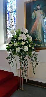 Bring the energy of a garden wedding indoors by adding potted trees, branches, and other greenery to the church. Church Wedding Flowers Pedestal Google Search Wedding Flower Arrangements Church Church Wedding Flowers Church Flowers