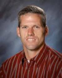 Sandy celebrates a state baseball title as its former coach Garet Luebbert  quietly listens