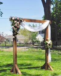 Well, do not forget to attach silk flowers, ferns and others to create the atmosphere of woodlands. Outdoor Wedding Ceremony Arch Idea Wooden Arch With Greenery And White Fabric Rus Outdoor Wedding Ceremony Arch Wedding Arches Outdoors Wedding Arch Rustic