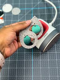 Open a jump ring with pliers, then with the jump ring open, slide on the faux leather earring, and then add the earring hook. Fabric And Faux Leather Earrings With Cricut Color Me Crafty