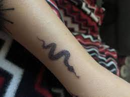 Load the needle with ink to get started. How To Tattoo Yourself At Home