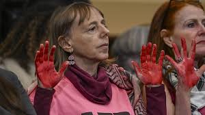 Anti-Israel protesters' painted red hands represent 'brutality'