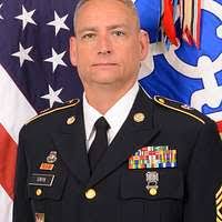 Capt. Paul O. Monger reads his orders prior to relieving