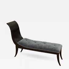 The chaise longue, also known as a day bed or fainting couch, is an upholstered couch with a high head rest on one side and open on the other, long enough to support the legs. Sabre Leg Art Deco Chaise In Black Lacquer Blue Velvet