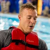 Aviation Ordnanceman Airman Elijah Harter and Information Systems  Technician 3rd Class Isabella Concepcion, assigned to USS Iwo Jima (LHD 7),  compete in the swim phase of the Search and Rescue competition during