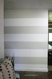 Whether you choose to adorn just one accent wall with painting basic stripes on the wall is easy enough: Diy Striped Accent Wall With Gray White Stripes Lolly Jane