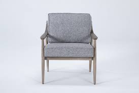 A white fireplace and ceiling beams balance dark walnut floors. Dena Grey Accent Chair Living Spaces