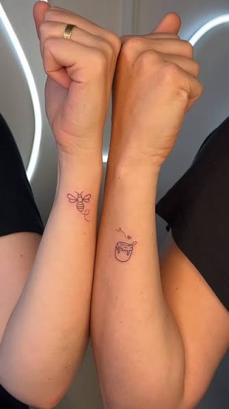 Matching tattoos for two best friends who have shared many years together. 🖤✨, They chose to capture their bond with a special symbol: 🐝 a bee and 🍯 honey., The bee stands for loyalty, support, and ...