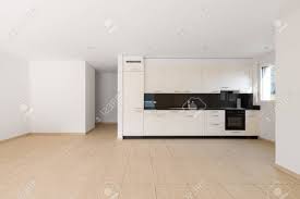 empty room with white walls, travertine