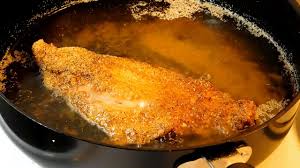 fried catfish fillet on a stove