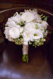 Bride S Bouquet Featuring White Ranunculus Lisianthus And Mini Carnations With Green Hydrangea And Wax Flower Acc Wax Flowers Mini Carnations White Ranunculus