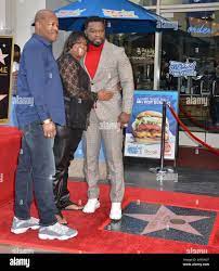 Los Angeles, USA. 30th Jan, 2020. Curtis 50 cents Jackson- star -037 dad  and mom 50 Cent poses with his star during the 50 Cent Walk Of Fame  Ceremony on January 30,