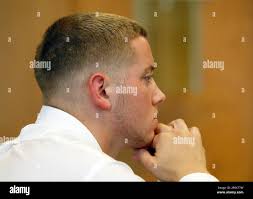 Defendant Aaron Deveau, 18, listens to testimony at Haverhill District  Court in Haverhill, Mass. Monday, June 4, 2012, where he is