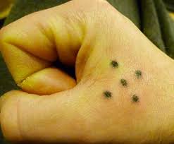 Negative space ornament tattoo on the palm. The Sinister Code Behind Prison Tattoos Including What A Teardrop Can Really Mean