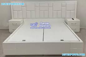 The bedroom is separated from the bathroom by a sliding barn door. New Modern White Bedroom Furniture Mandap Exporters
