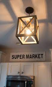 35 Diy Farmhouse Kitchen Decor Projects To Upgrade Your Kitchen On A Budget Lantern Light Fixture Diy Light Fixtures Diy Kitchen Lighting